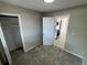 View of a bedroom with neutral paint, carpet, closet, and doorway to kitchen at 6624 Kristin Ct, Orlando, FL 32818