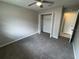 This bedroom features carpet, a ceiling fan with light, and a closet with white bi-fold doors at 6624 Kristin Ct, Orlando, FL 32818