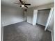 This bedroom features carpet, a ceiling fan with light, and a closet with white bi-fold doors at 6624 Kristin Ct, Orlando, FL 32818