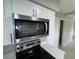 Stainless steel Whirlpool microwave above stainless steel oven and quartz countertops at 6624 Kristin Ct, Orlando, FL 32818