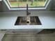 Stainless steel kitchen sink with a sleek faucet and quartz countertops at 6624 Kristin Ct, Orlando, FL 32818