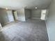 Open living area with tiled entry leading to a spacious carpeted living room at 6624 Kristin Ct, Orlando, FL 32818