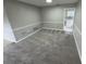 Carpeted living room featuring decorative trim and a view into the adjacent kitchen at 6624 Kristin Ct, Orlando, FL 32818