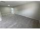 Spacious carpeted living room offering easy access to the kitchen at 6624 Kristin Ct, Orlando, FL 32818