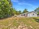 Spacious backyard featuring an in-ground pool, partial fencing, and lush greenery at 7614 Sw 80Th St, Ocala, FL 34476