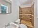 Tiled shower in this bathroom features built-in shelves, and a window with bright, natural light at 7614 Sw 80Th St, Ocala, FL 34476