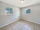 A simple bedroom with tiled flooring, natural light, and potential for personalization at 7614 Sw 80Th St, Ocala, FL 34476
