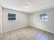 A bedroom featuring tile floor and natural light from two windows at 7614 Sw 80Th St, Ocala, FL 34476