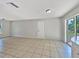 Open living area with tile floors and a view of the backyard through sliding glass doors at 7614 Sw 80Th St, Ocala, FL 34476