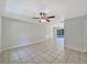 A neutral-toned living space with tiled flooring and an open layout leading to a pool view at 7614 Sw 80Th St, Ocala, FL 34476