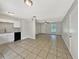 Well-lit living space with neutral walls connecting kitchen and entrance at 7614 Sw 80Th St, Ocala, FL 34476