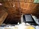 Exposed attic space with wooden beams and some insulation at 825 Poinsettia Dr, Eustis, FL 32726