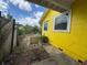 Image of the backyard with a fenced-in area and foliage on a sunny day at 825 Poinsettia Dr, Eustis, FL 32726