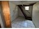 Basement space with white tiled floor and stairs at 825 Poinsettia Dr, Eustis, FL 32726