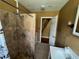Modest bathroom featuring a tiled shower, single sink vanity, and a doorway to another room at 825 Poinsettia Dr, Eustis, FL 32726