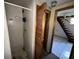 Compact bathroom features a shower stall and an adjacent closet or storage area at 825 Poinsettia Dr, Eustis, FL 32726