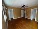 View of a bedroom with two closets and hardwood floors at 825 Poinsettia Dr, Eustis, FL 32726