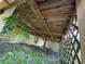 Exterior view of a home showing a wooden deck ceiling and overgrown lawn at 825 Poinsettia Dr, Eustis, FL 32726
