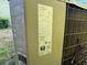 Image shows the model and serial number of an outdoor HVAC unit at 825 Poinsettia Dr, Eustis, FL 32726