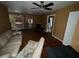 Living room features a fireplace, ceiling fan, and hardwood floors at 825 Poinsettia Dr, Eustis, FL 32726