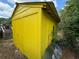 Angled exterior view of a yellow storage shed at 825 Poinsettia Dr, Eustis, FL 32726