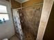 Modest tile shower with shower curtain and toiletry products in a naturally lit bathroom at 825 Poinsettia Dr, Eustis, FL 32726