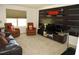 Recreational room furnished with dark furniture, entertainment center and treadmill at 9005 Reflection Pointe Dr, Windermere, FL 34786