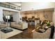 Open-concept living room with a modern kitchen, dark wood floors, and lots of seating at 9005 Reflection Pointe Dr, Windermere, FL 34786