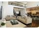 Open-concept living room with a modern kitchen, dark wood floors, and a staircase at 9005 Reflection Pointe Dr, Windermere, FL 34786