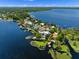 Breathtaking aerial view of waterfront homes, lush greenery, and sparkling blue lake at 9916 Lone Tree Ln, Orlando, FL 32836