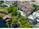 Stunning aerial view of a luxury waterfront home with a private pool and boat dock on a picturesque lake at 9916 Lone Tree Ln, Orlando, FL 32836