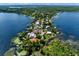 Breathtaking aerial view of a waterfront community, showcasing luxurious homes surrounded by sparkling lakes and lush greenery at 9916 Lone Tree Ln, Orlando, FL 32836