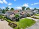 Lovely aerial view of a home with manicured lawns, lush landscaping, and waterfront access on a bright, sunny day at 9916 Lone Tree Ln, Orlando, FL 32836