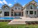 Stunning backyard featuring a sparkling pool, stone patio, and manicured landscaping at 9916 Lone Tree Ln, Orlando, FL 32836