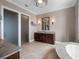 Bathroom with tile floors, granite countertops and a large soaking tub at 9916 Lone Tree Ln, Orlando, FL 32836