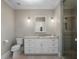 Bathroom featuring a glass enclosed shower, granite countertop and large mirror at 9916 Lone Tree Ln, Orlando, FL 32836