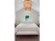 Bedroom features a decorative chandelier, a large window and matching bedside tables at 9916 Lone Tree Ln, Orlando, FL 32836