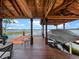Covered boat dock with a boat lift, offering direct access to the tranquil lake at 9916 Lone Tree Ln, Orlando, FL 32836