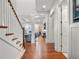 Bright entryway with wood floors and staircase leading to an open-concept living area at 9916 Lone Tree Ln, Orlando, FL 32836