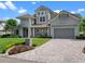 Charming gray home with a well-manicured lawn, lush landscaping, and inviting front porch at 9916 Lone Tree Ln, Orlando, FL 32836