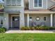 Charming front porch with comfortable seating, lush greenery, and an inviting entrance to a beautiful home at 9916 Lone Tree Ln, Orlando, FL 32836