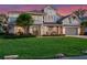 Charming gray home with a well-manicured lawn, lush landscaping, and inviting front porch at 9916 Lone Tree Ln, Orlando, FL 32836