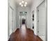 Hallway with hardwood floors, white trim, and decorative glass transom window at 9916 Lone Tree Ln, Orlando, FL 32836