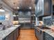 Gourmet kitchen equipped with stainless steel appliances, granite countertops, and ample custom cabinetry at 9916 Lone Tree Ln, Orlando, FL 32836