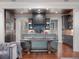 Charming kitchen boasting an island with seating, modern pendant lighting, and stainless steel appliances at 9916 Lone Tree Ln, Orlando, FL 32836