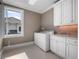 Laundry room featuring a window, washer and dryer, storage and granite countertops at 9916 Lone Tree Ln, Orlando, FL 32836