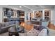 Elegant living room featuring hardwood floors, multiple sofas, and seamlessly integrates with the gourmet kitchen at 9916 Lone Tree Ln, Orlando, FL 32836