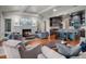 Spacious living room with fireplace, TV, and open access to the modern kitchen and dining area at 9916 Lone Tree Ln, Orlando, FL 32836