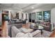 Open-concept living room with water views, plush seating and access to outdoor amenities at 9916 Lone Tree Ln, Orlando, FL 32836