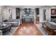 Open concept living room with grey couches, wood flooring, and kitchen with central island at 9916 Lone Tree Ln, Orlando, FL 32836